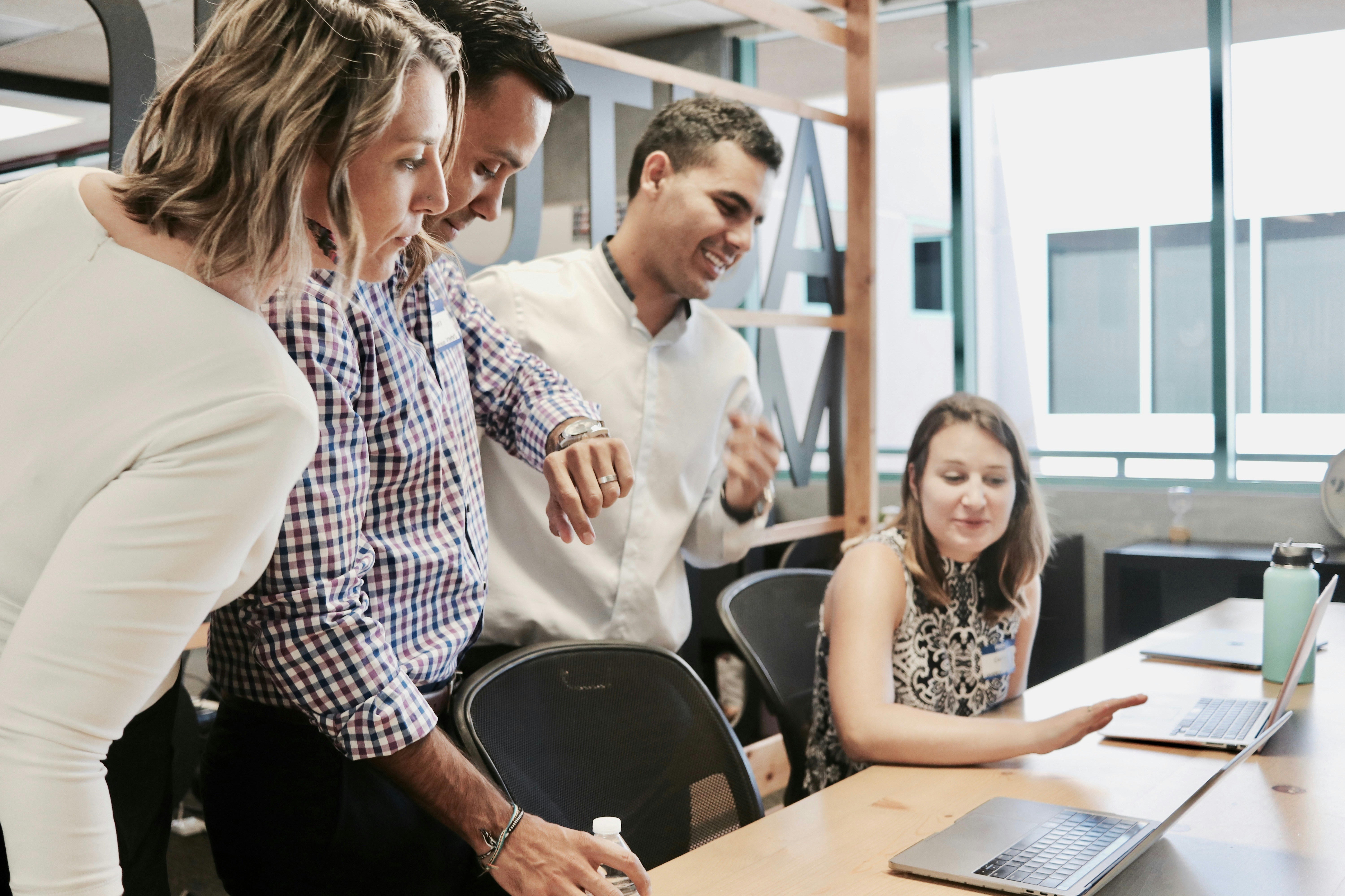 People in an office looking at a screen