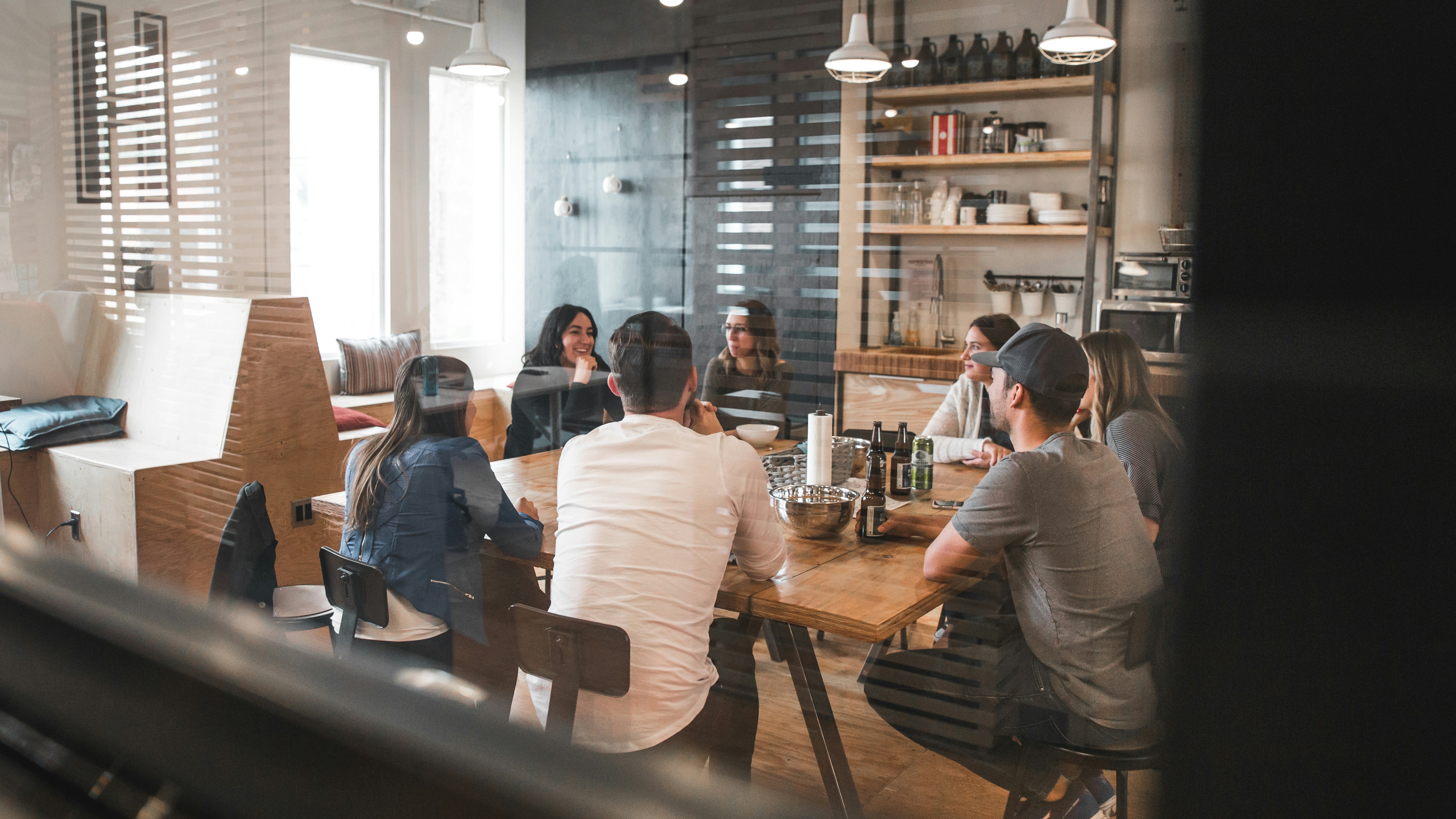 people sitting around a table having a meeting